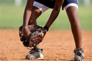 Softball player preparing to catch a ground ball.
